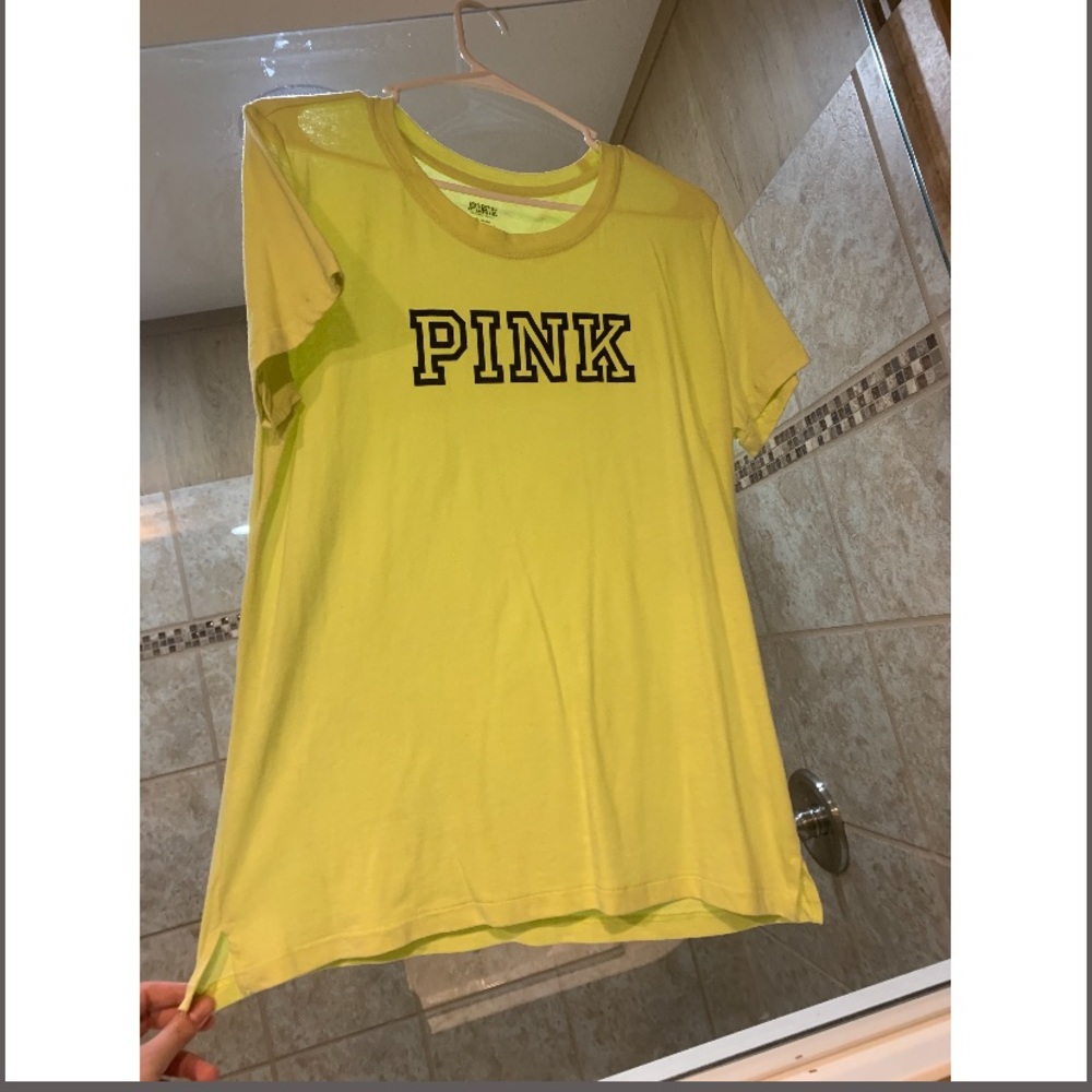 NEON YELLOW VICTORIA SECRET T-SHIRT WITH BLACK WRITING.